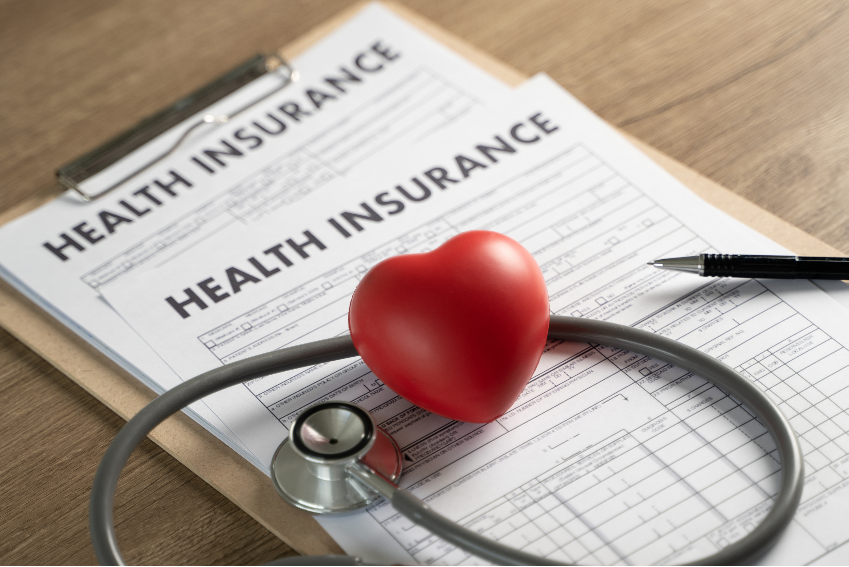 Health insurance needs met | clip boards with papers, heart, and stetahascope